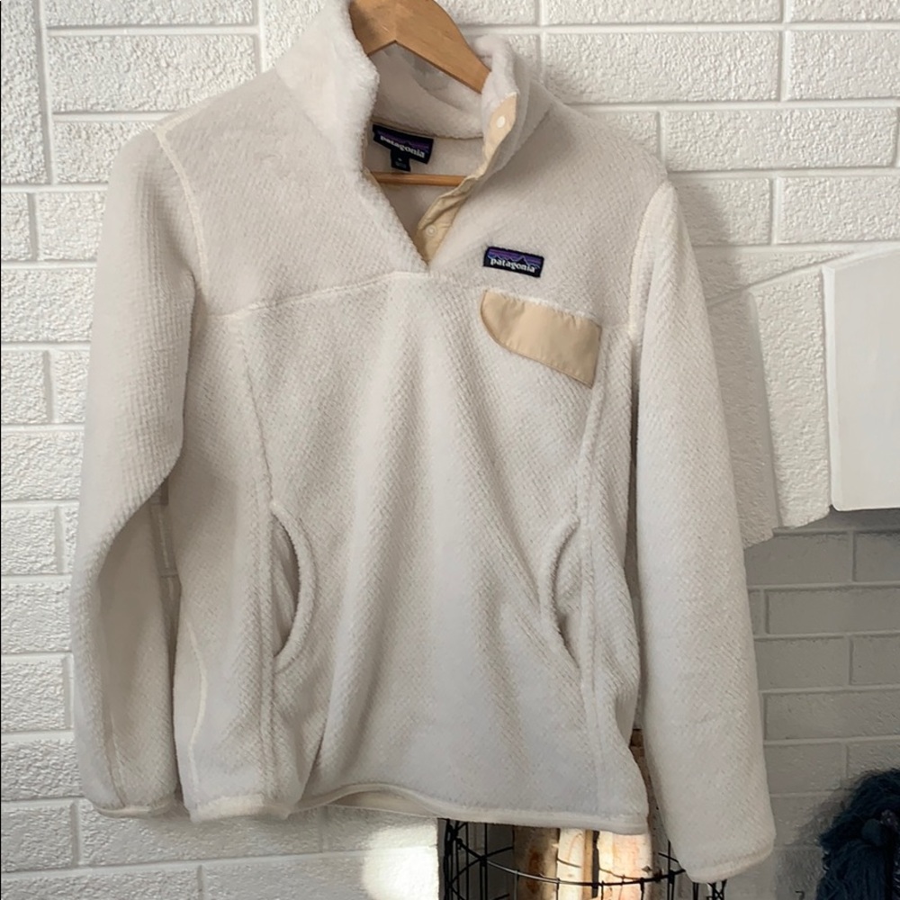 White Patagonia sweater with cream trim